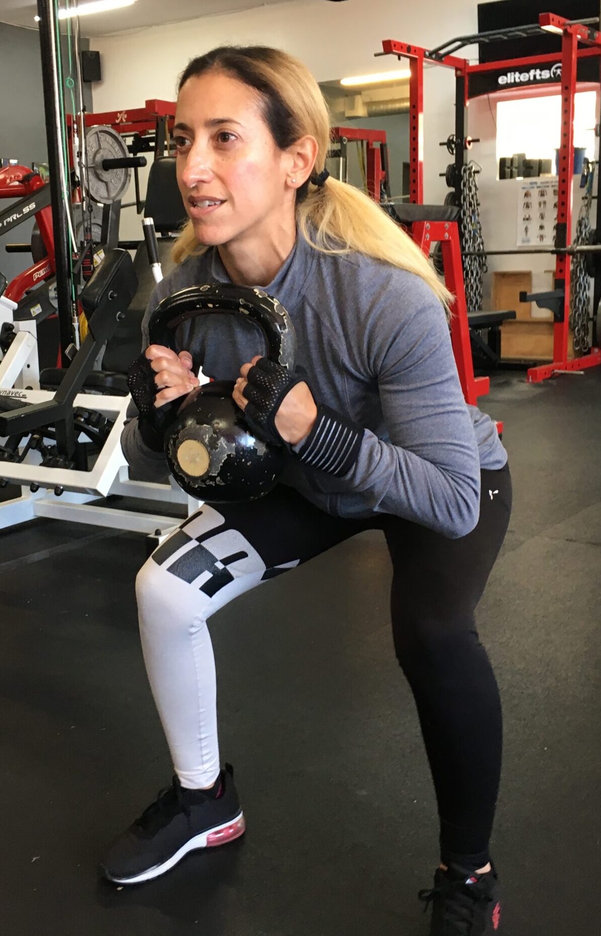 Vilita Cruz holding weights in position