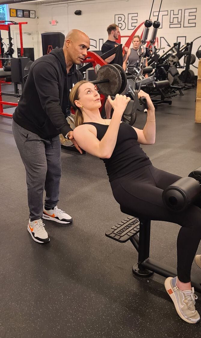 Client Highlight Noni with her trainer Nick doing a lat pull down