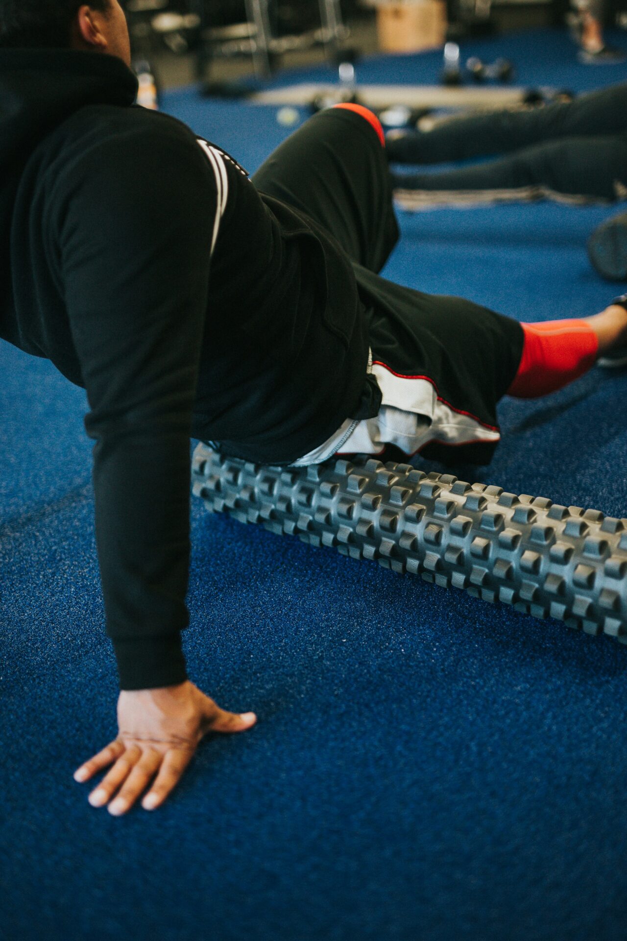A person using a foam roller to recover