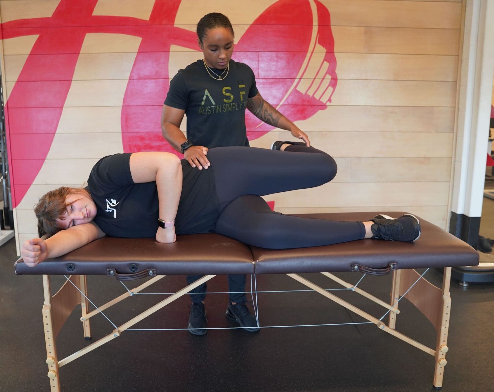 Coach Sierra Nevels assesses the hip movement of a client