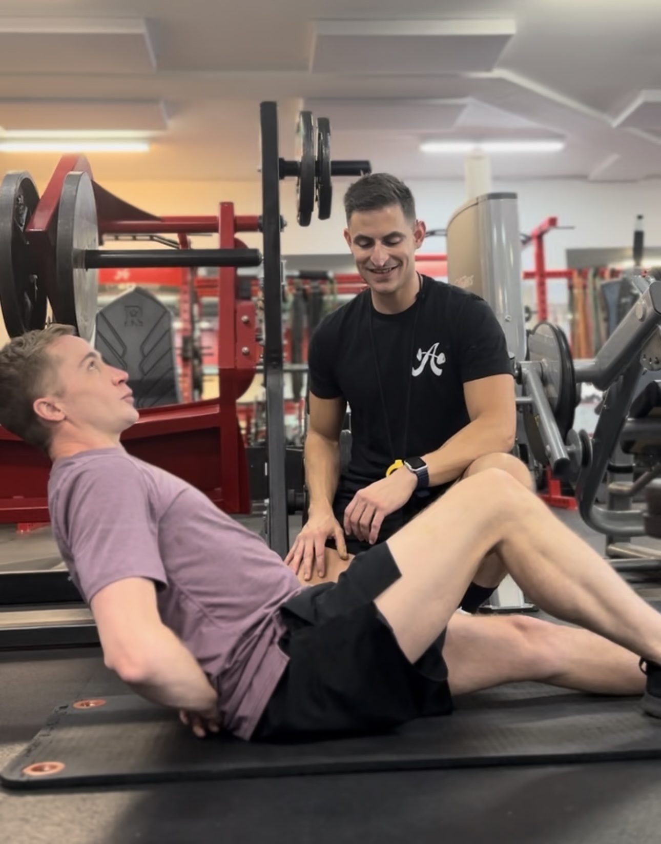 Coach Danny doing a movement assessment on a client