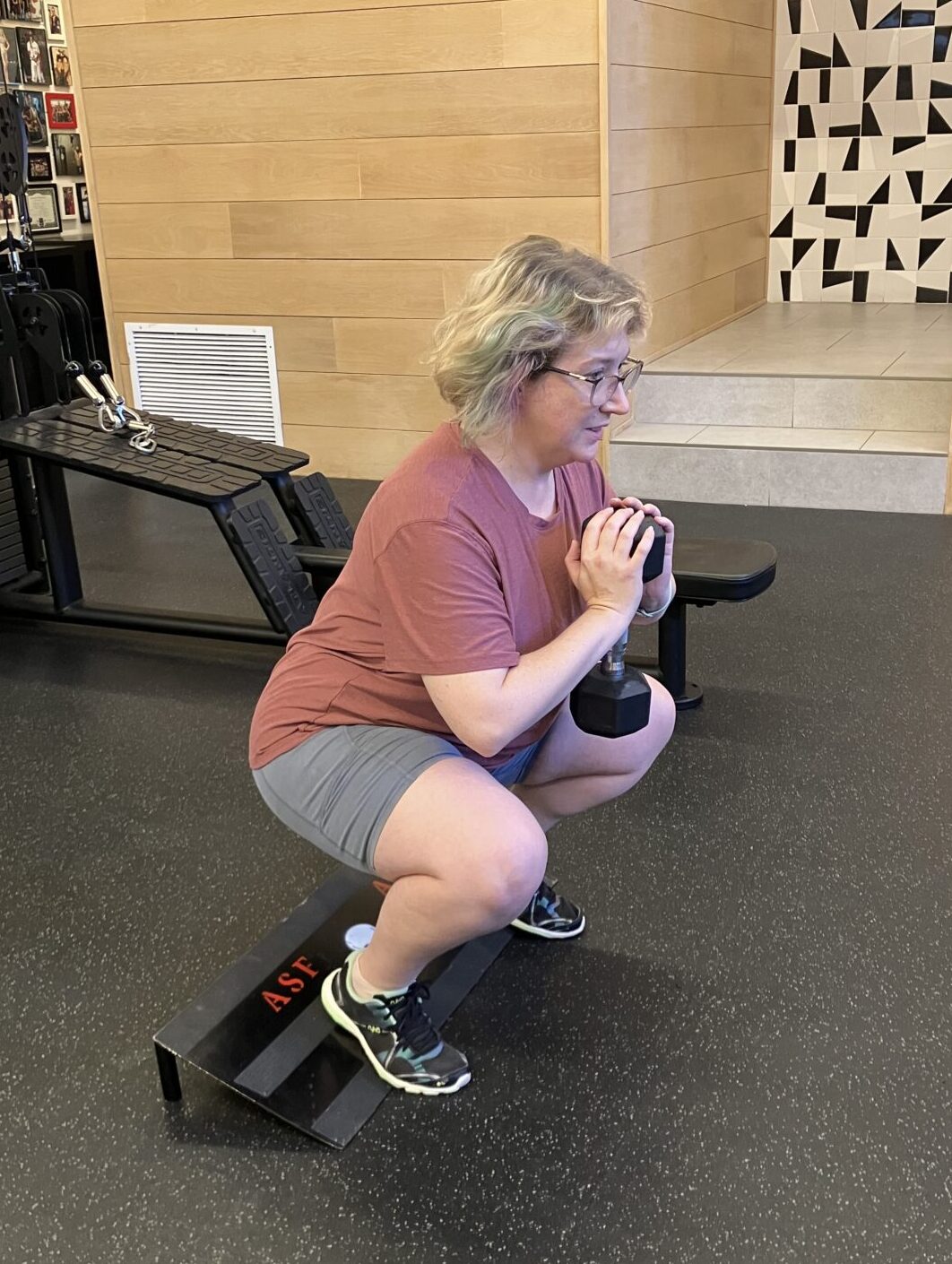 Client highlight Elizabeth doing a goblet squat on a slant board